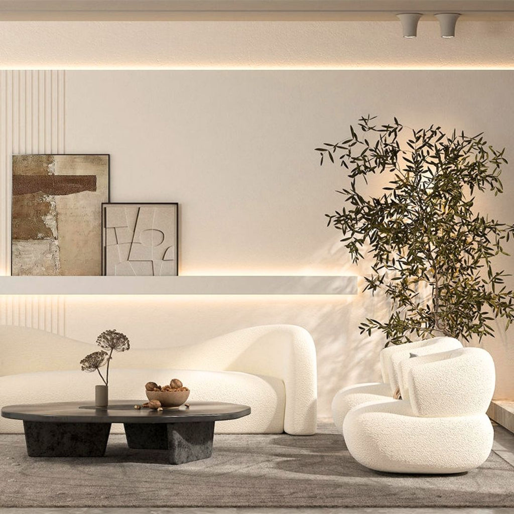 Skulpturell buet sofa og lenestol i bouclé
